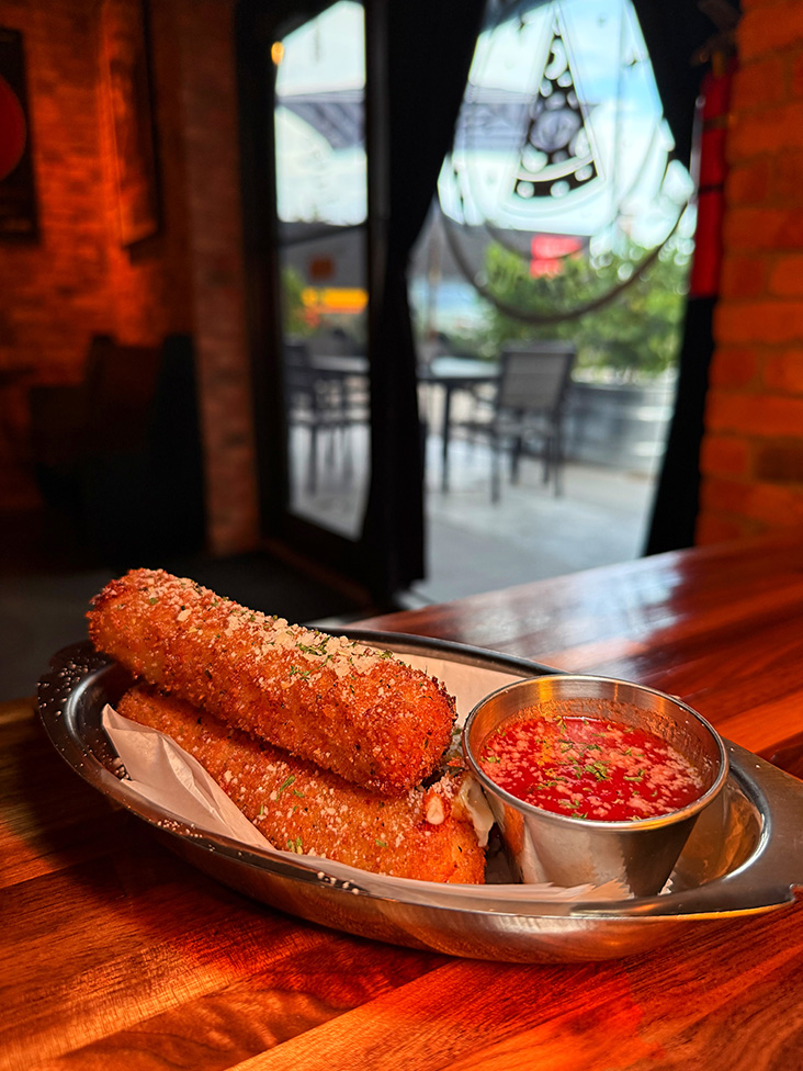 Mozzarella sticks with marinara dipping sauce.